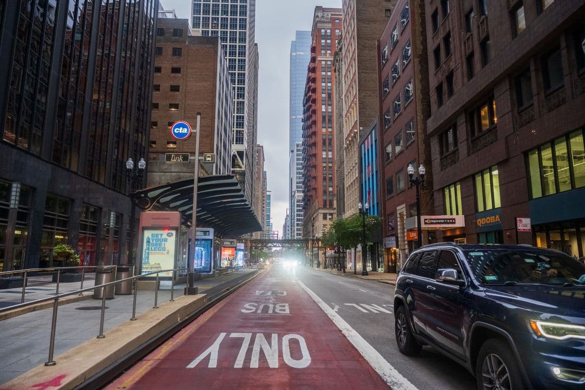 Downtown Chicago street view featuring a CTA bus lane and urban architecture.
